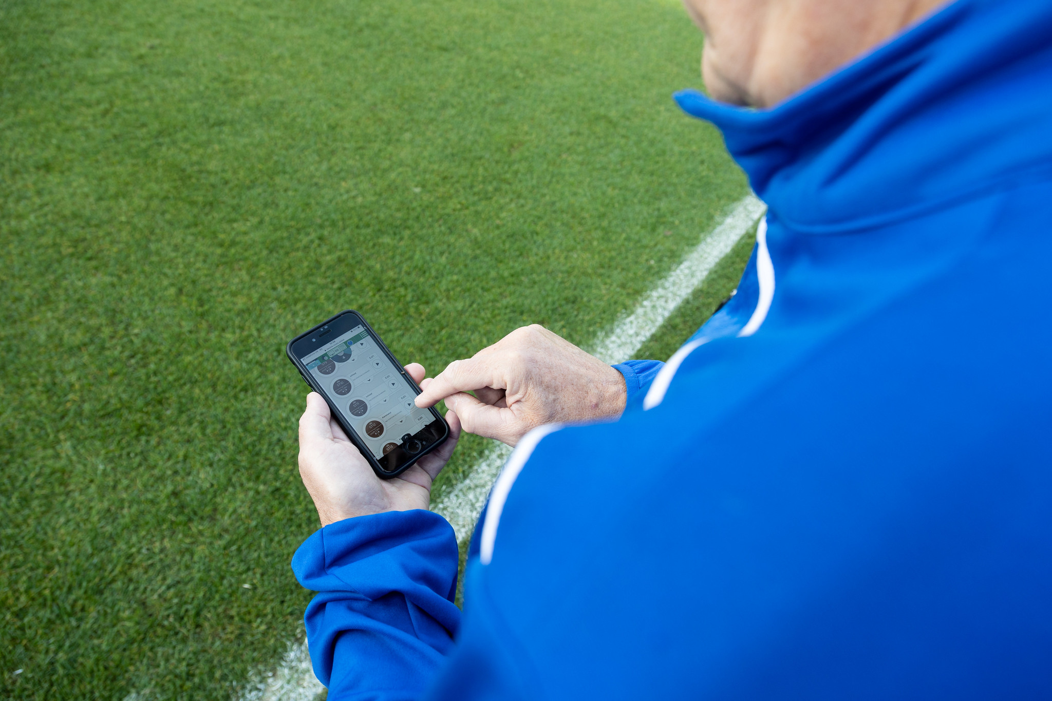 Sutton United FC groundskeeper controlling the Toro Irrigation system using a mobile phone.